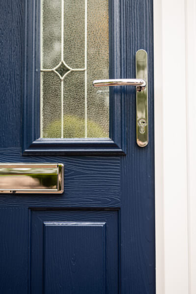 A navy blue composite door.