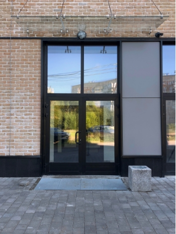 Anthracite grey uPVC French doors with a top light, absorbing summer heat.