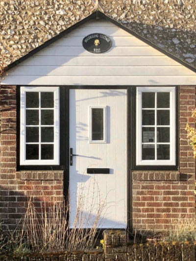 white composite doors surrey with black frame in brick porch
