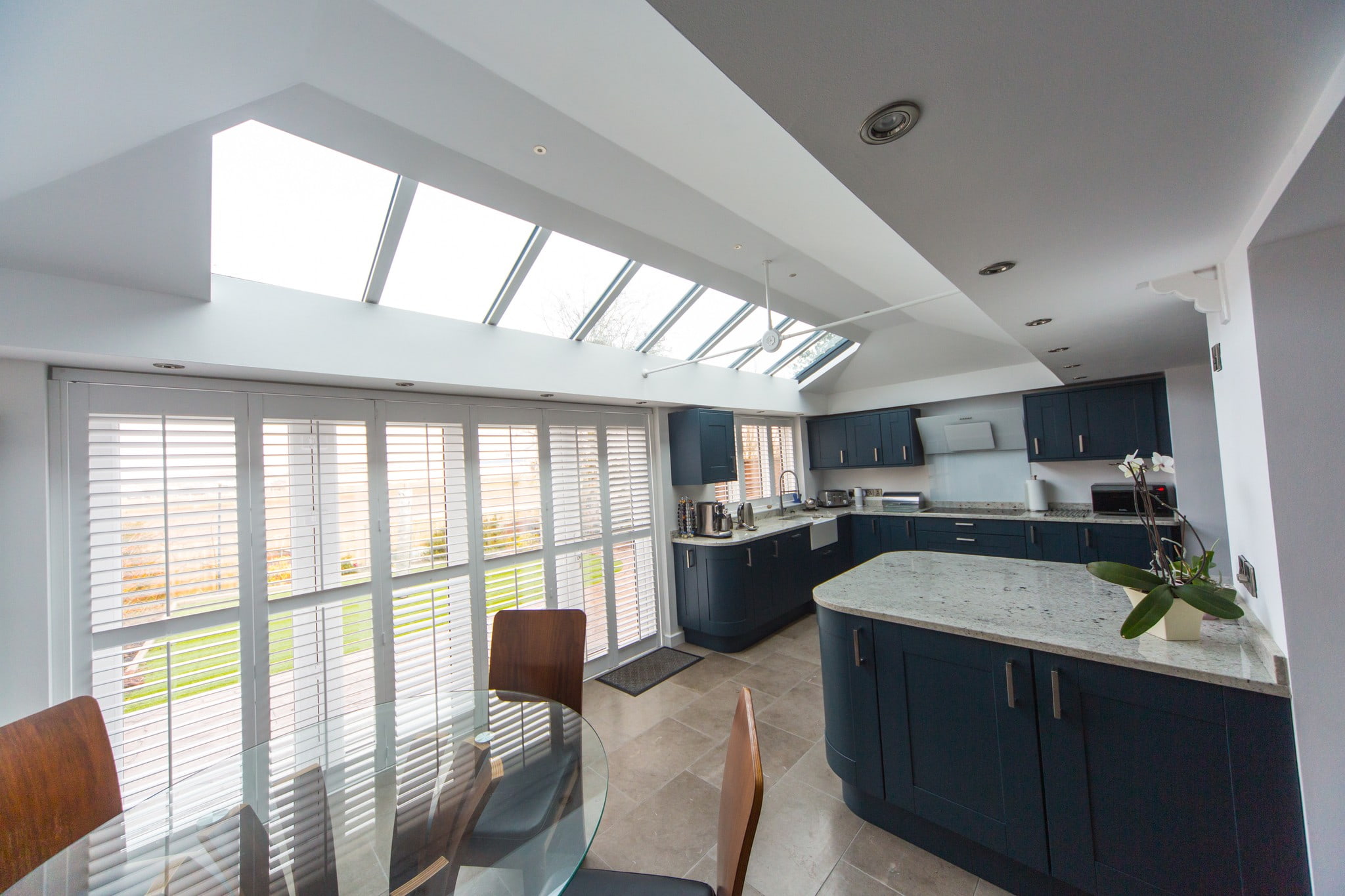 A modern, white, kitchen diner extension.