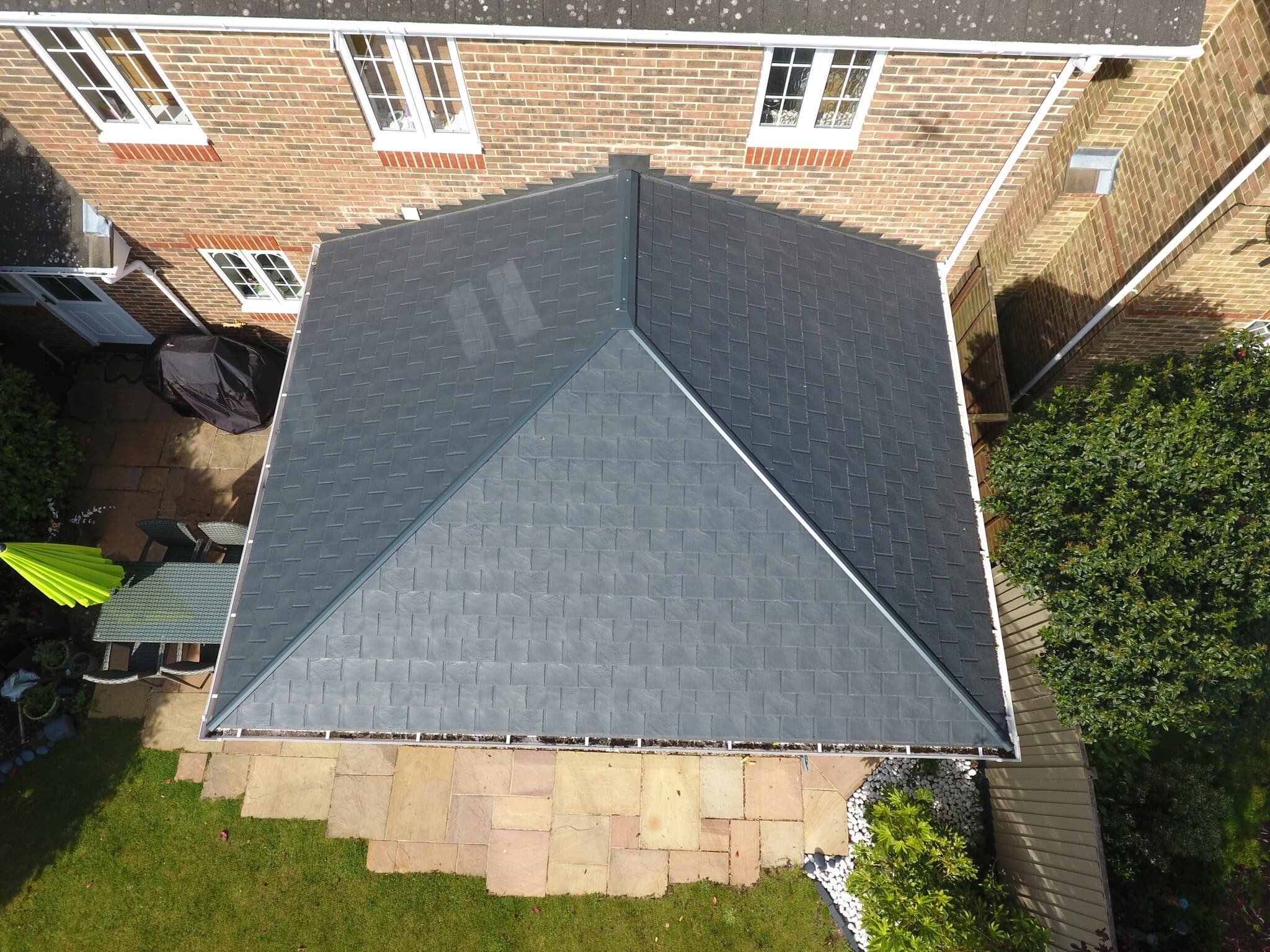 A bird's eye view of a tiled roof extension.