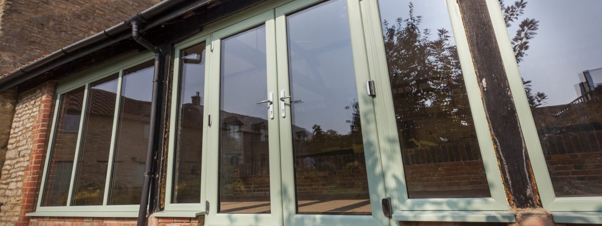 Green french doors in a conservatory