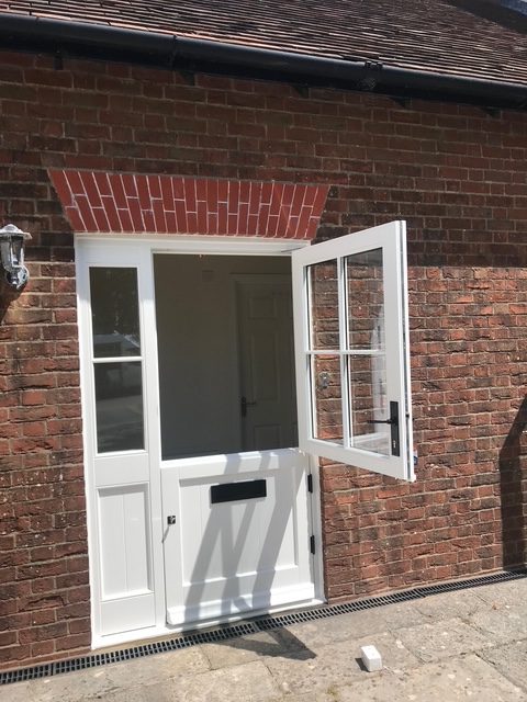 A timber stable door with the top half open for ventilation