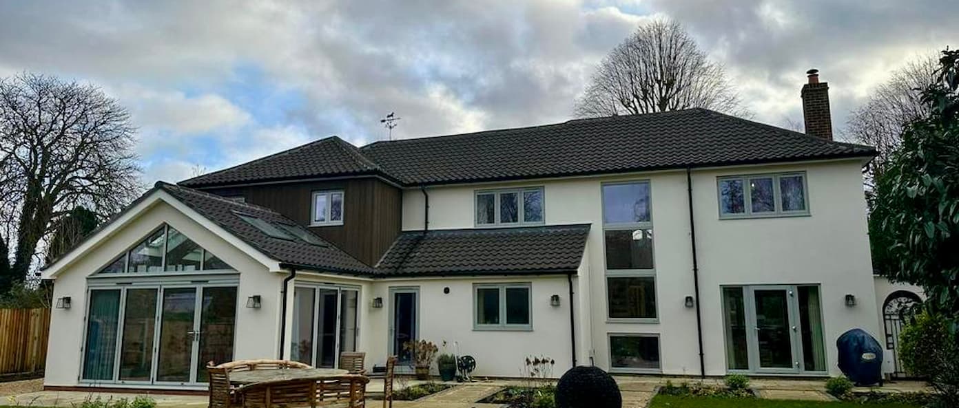 A stunning modern property expertly blending uPVC flush casement windows with large aluminium bifold doors