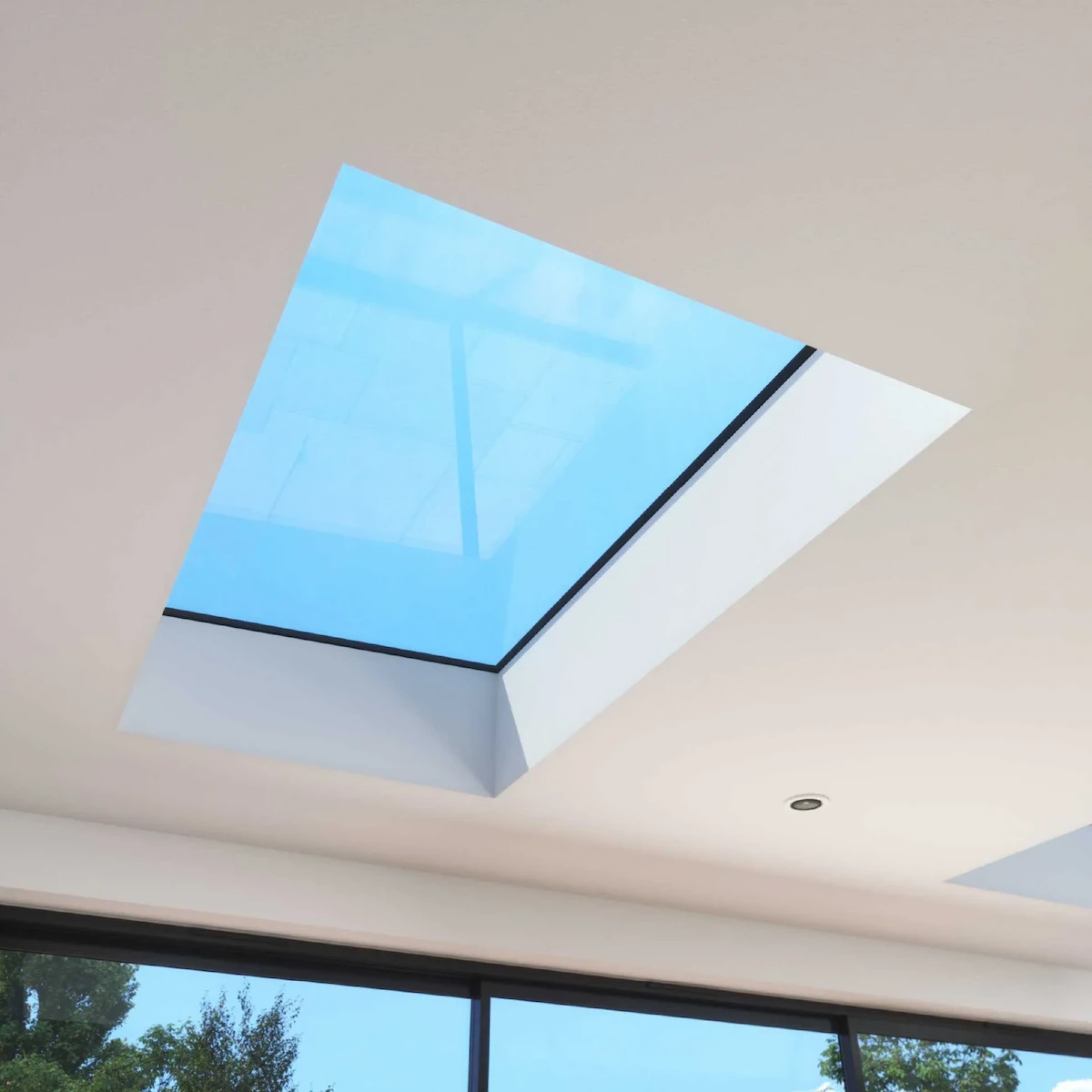 A sleek Korniche flat roof light installed flush with the ceiling