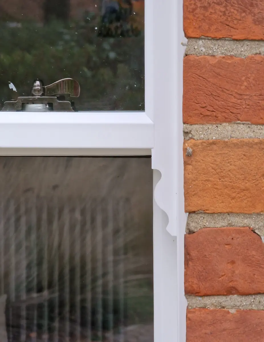 A highly detailed close up specifically showing an authentic run-through sash horn on a uPVC window