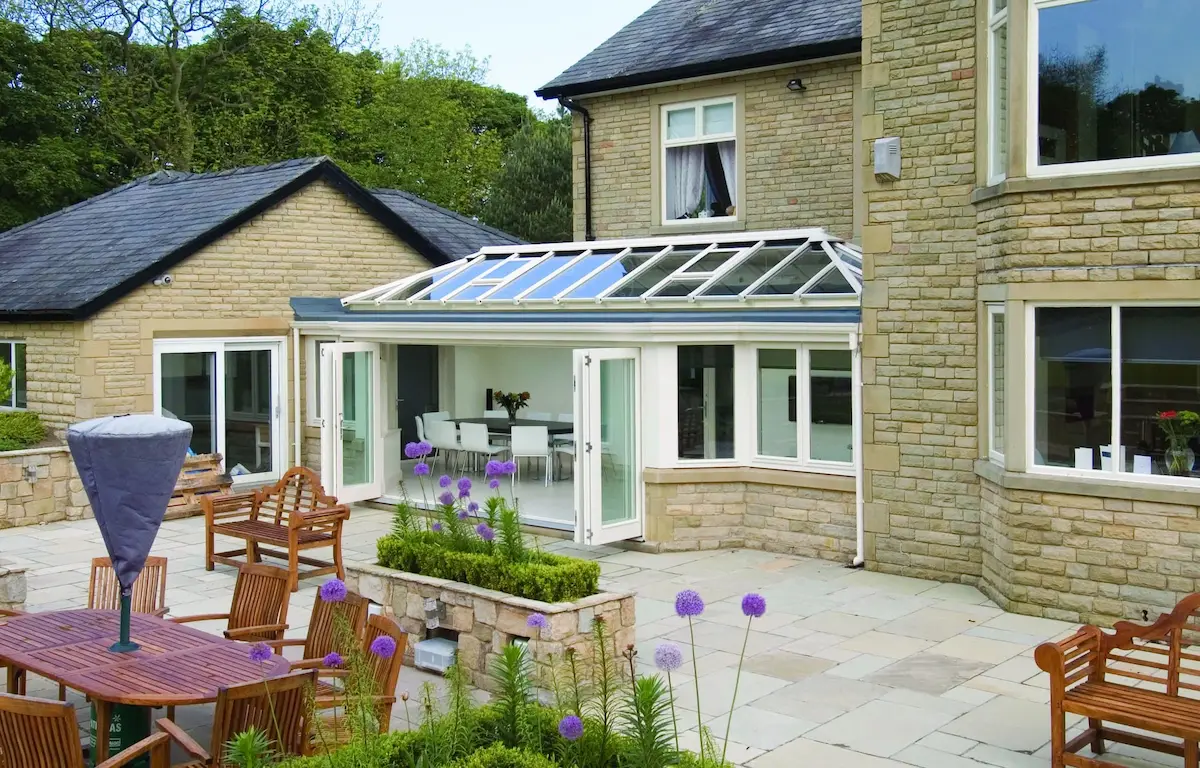 A modern glass roof conservatory featuring high-performance solar control glass