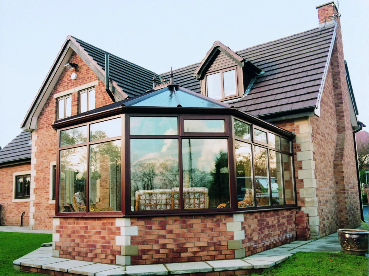 A large brick Victorian conservatory.