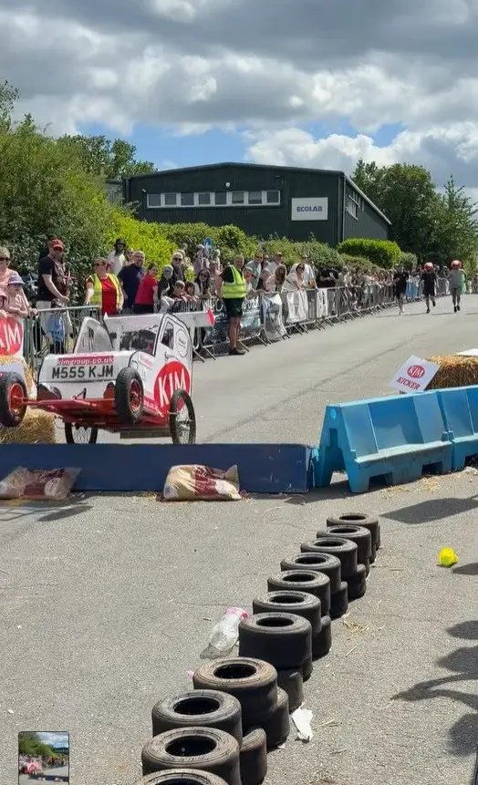A soapbox kart launching off the KJM Kicker ramp at the start of the race