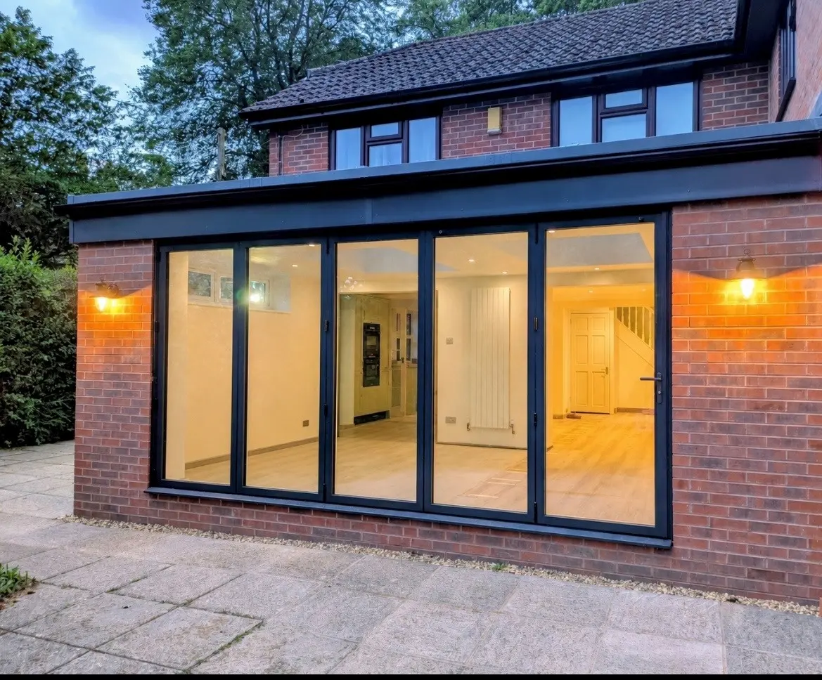 The stunning exterior of the finished Ultraframe flat roof extension at dusk in Romsey