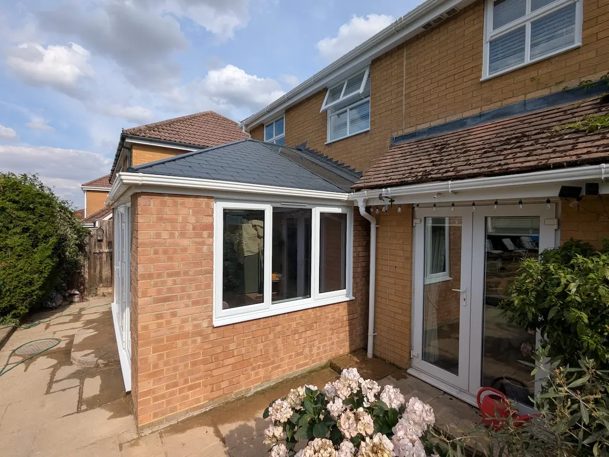 A modern brick conservatory retrofitted with a solid tiled roof conversion
